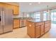 Stainless steel refrigerator in kitchen with island and stainless steel dishwasher at 9017 Se 119Th St, Summerfield, FL 34491