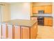 Lovely kitchen island with wooden cabinets, granite countertops, and stainless steel appliances at 9017 Se 119Th St, Summerfield, FL 34491