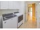 Bright laundry room features front load washer and dryer, tiled floor, and white cabinets for storage at 9017 Se 119Th St, Summerfield, FL 34491