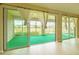 A beautifully sunlit, screened lanai with views of the green backyard at 9017 Se 119Th St, Summerfield, FL 34491