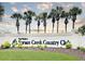 Del Webb's Spruce Creek Country Club sign, showcasing lush landscaping and a welcoming entrance at 9017 Se 119Th St, Summerfield, FL 34491