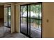 A view of the balcony with black railings leading to an outside view of trees and landscaping at 925 Fenton Ln # 18, Lakeland, FL 33809