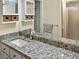 Bathroom with granite countertop, mirrored medicine cabinet, and closet at 925 Fenton Ln # 18, Lakeland, FL 33809