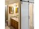 This bathroom features a sink with granite countertop and sliding barn door at 925 Fenton Ln # 18, Lakeland, FL 33809