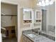 Bathroom vanity with granite countertop, mirrored medicine cabinet and closet at 925 Fenton Ln # 18, Lakeland, FL 33809