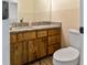 Bathroom featuring a granite countertop, wood cabinets, and a modern faucet at 925 Fenton Ln # 18, Lakeland, FL 33809