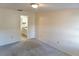 Neutral bedroom with carpeted floors and a view into the en suite bathroom at 925 Fenton Ln # 18, Lakeland, FL 33809