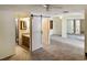 This bedroom has two ceiling fans and a bathroom with a sliding barn door at 925 Fenton Ln # 18, Lakeland, FL 33809