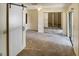 Spacious bedroom with sliding glass doors to balcony and a barn door leading to an adjacent room at 925 Fenton Ln # 18, Lakeland, FL 33809