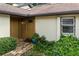 Charming home entrance featuring a stylish front door, brick walkway, and lush landscaping at 925 Fenton Ln # 18, Lakeland, FL 33809