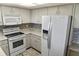 Modern kitchen with white cabinets, granite countertops, and stainless appliances at 925 Fenton Ln # 18, Lakeland, FL 33809