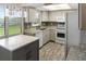 Modern kitchen features white cabinets, granite countertops, an island, and stainless appliances at 925 Fenton Ln # 18, Lakeland, FL 33809