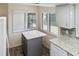 Well-lit kitchen featuring a gray island with white countertop and views from the windows at 925 Fenton Ln # 18, Lakeland, FL 33809