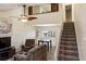 Bright living room features a vaulted ceiling, fan, stairs, and natural light at 925 Fenton Ln # 18, Lakeland, FL 33809