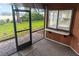 Screened porch with exterior view of the home's lawn and a vintage pass-through window at 925 Fenton Ln # 18, Lakeland, FL 33809