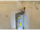Compact utility room featuring a new hot water heater and basic shelving at 925 Fenton Ln # 18, Lakeland, FL 33809