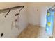 Utility room with a water heater, wall shelving, and tile floors ready for maintenance at 925 Fenton Ln # 18, Lakeland, FL 33809