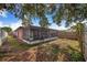 Spacious backyard showing brick exterior and large, screened-in patio at 1523 Mariner Rd, Lakeland, FL 33803