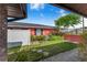 Private backyard showcasing lush landscaping, a white fence, and a charming outdoor space at 1523 Mariner Rd, Lakeland, FL 33803