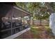 View of screen-enclosed back patio, backyard and privacy fence at 1523 Mariner Rd, Lakeland, FL 33803
