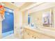 Bathroom with blue-tiled shower, white vanity, and neutral walls at 1523 Mariner Rd, Lakeland, FL 33803