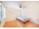 Minimalist bedroom with natural light, neutral walls, and wood-look flooring at 1523 Mariner Rd, Lakeland, FL 33803
