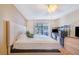 Cozy bedroom with sliding glass doors, desk area, wood-look floors and neutral color scheme at 1523 Mariner Rd, Lakeland, FL 33803