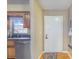 Inviting entryway with hardwood floors, a white door, and a glimpse of the modern kitchen at 1523 Mariner Rd, Lakeland, FL 33803