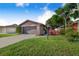 Charming home featuring a brick facade, well-maintained landscaping, and a two-car garage at 1523 Mariner Rd, Lakeland, FL 33803