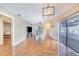Bright living room with hardwood floors, a ceiling fan, and sliding glass doors to the backyard at 1523 Mariner Rd, Lakeland, FL 33803