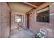 Welcoming covered porch with brickwork and a comfortable seating area by the front door at 1523 Mariner Rd, Lakeland, FL 33803