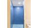 Bathroom shower featuring blue tiles and a glass shelf at 1523 Mariner Rd, Lakeland, FL 33803