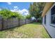 Spacious backyard featuring a wood fence, mature tree, and plenty of room for outdoor activities at 1081 Sunshine Sw Way, Winter Haven, FL 33880