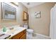 Functional bathroom with a vanity, framed mirror, toilet, and a shower with a curtain at 1081 Sunshine Sw Way, Winter Haven, FL 33880