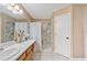 Bathroom with a single sink vanity, marble countertops, and tiled shower at 1081 Sunshine Sw Way, Winter Haven, FL 33880