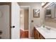 Bathroom showing a white door, tile floor, a vanity with mirror and an entry view at 1081 Sunshine Sw Way, Winter Haven, FL 33880