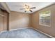 Bedroom featuring neutral paint, new carpet, a ceiling fan, and a closet at 1081 Sunshine Sw Way, Winter Haven, FL 33880