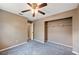 Neutral bedroom featuring a ceiling fan, plush carpeting, and a spacious closet for ample storage at 1081 Sunshine Sw Way, Winter Haven, FL 33880