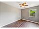 Bedroom with laminate wood floors, neutral paint, a window and a ceiling fan at 1081 Sunshine Sw Way, Winter Haven, FL 33880