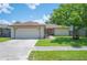 Charming single-story home with a well-manicured lawn, mature tree, and an attached two-car garage at 1081 Sunshine Sw Way, Winter Haven, FL 33880