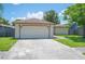 Single-story home with a two-car garage, well-maintained lawn, and inviting curb appeal at 1081 Sunshine Sw Way, Winter Haven, FL 33880