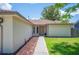 A walkway leads to the front door of the house, complemented by meticulously arranged landscaping at 1081 Sunshine Sw Way, Winter Haven, FL 33880