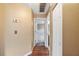 Hallway with wood floors, leading to other rooms, offering a view of the home's interior layout at 1081 Sunshine Sw Way, Winter Haven, FL 33880