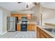 A kitchen featuring wooden cabinets, stainless steel appliances, and a ceiling fan at 1081 Sunshine Sw Way, Winter Haven, FL 33880