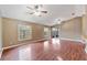 Spacious living room with vaulted ceilings, wood laminate flooring, and large windows for natural light at 1081 Sunshine Sw Way, Winter Haven, FL 33880