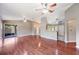 Bright, open living space with vaulted ceilings, wood laminate flooring, and sliding glass door at 1081 Sunshine Sw Way, Winter Haven, FL 33880