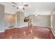 Open-concept layout featuring wood laminate flooring, neutral paint, and seamless transition to the kitchen at 1081 Sunshine Sw Way, Winter Haven, FL 33880
