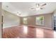 Spacious living room with vaulted ceilings, wood laminate flooring, and large windows for natural light at 1081 Sunshine Sw Way, Winter Haven, FL 33880