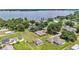 Wide aerial view showing the house, large yard, and proximity to a lake at 113 W Juliana Way, Auburndale, FL 33823