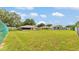 Large backyard with mature trees and green chain link fence at 113 W Juliana Way, Auburndale, FL 33823